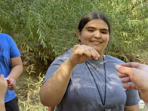 Smiling girl holding a dragonfly 