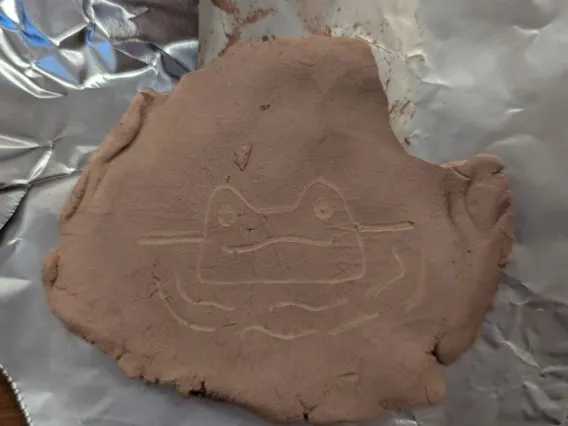 Example of student created petroglyph of frog in water