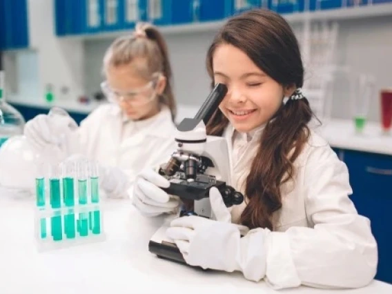 Students Analyzing Samples Under A Microscope