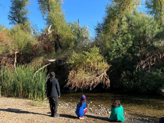 Three students by the Santa Cruz River