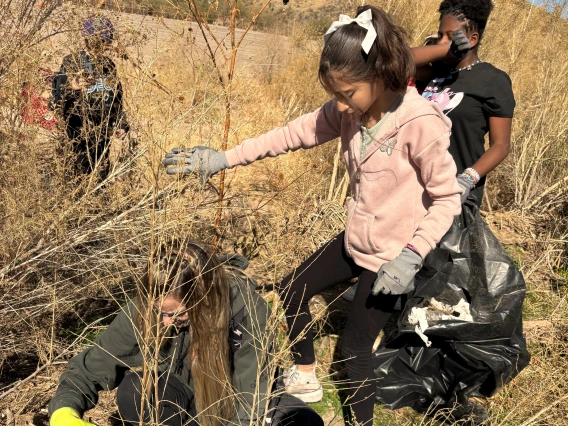 Students collecting trash in the Santa Cruz River