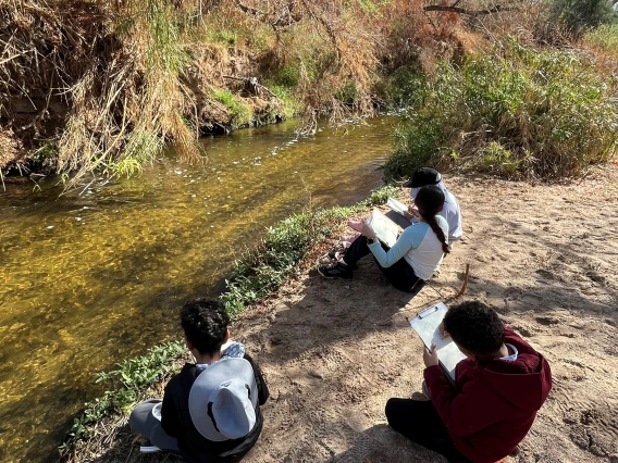 Students drawing the Santa Cruz River on a field trip