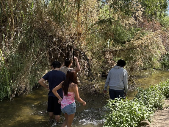 Students walking in the Santa Cruz River on a field trip