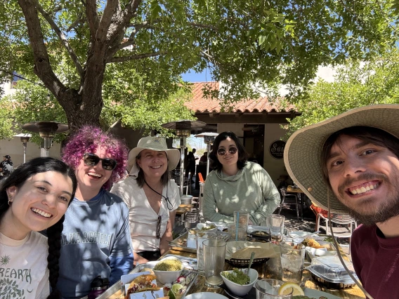 Group of people sitting at a table sharing a meal