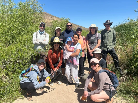 Group of people standing near the Santa Cruz River