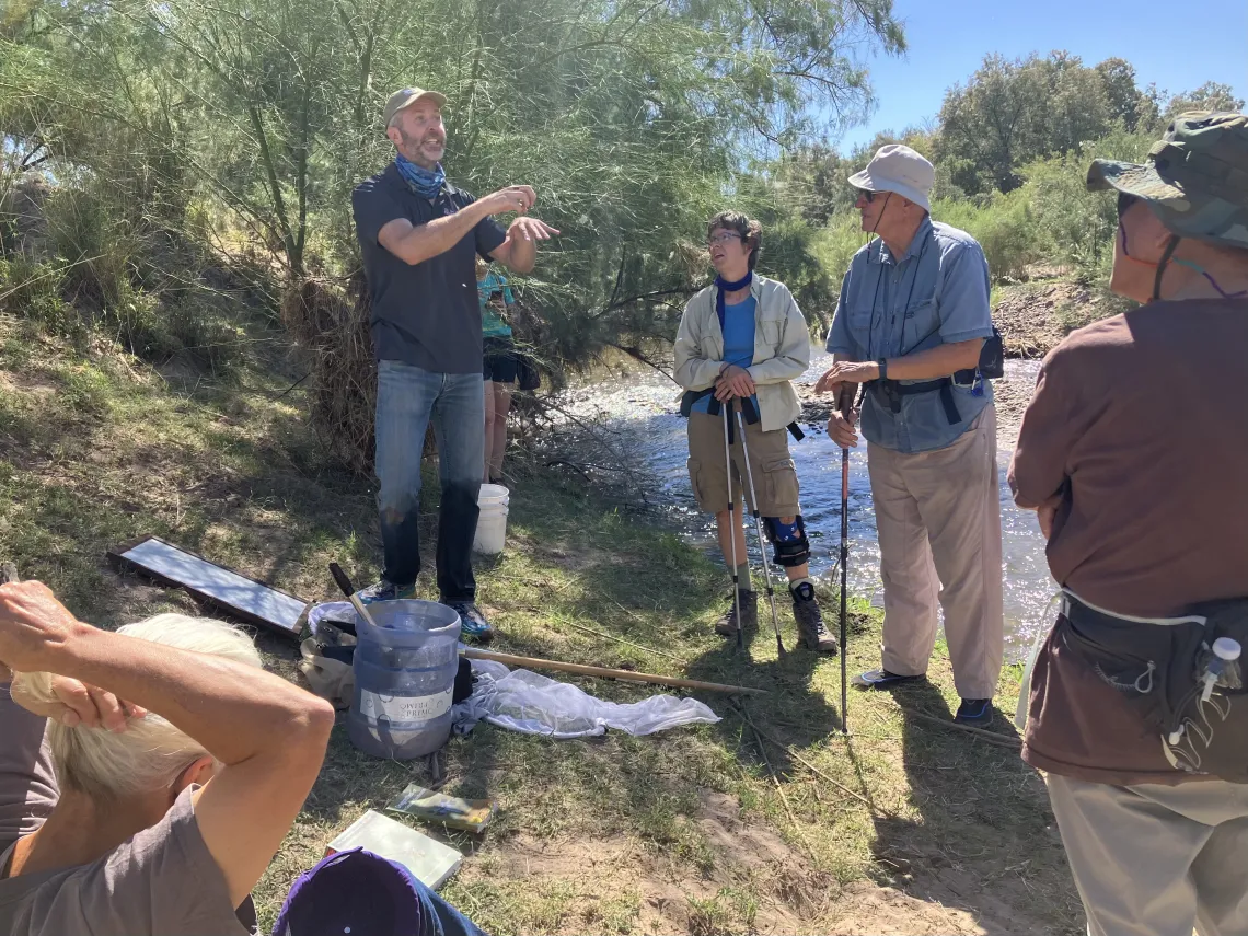 Group of people listening to speaker on Santa Cruz River