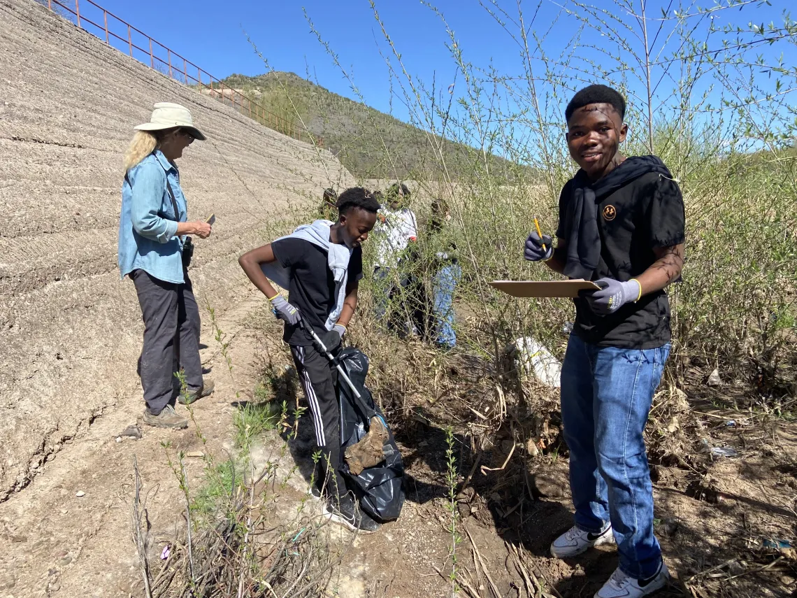 Two students collecting trash