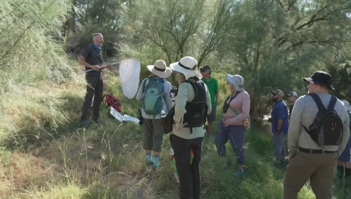 People standing by the Santa Cruz River on Dragonfly Tour