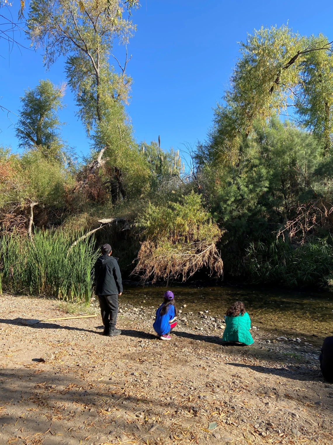 Three students by the Santa Cruz River