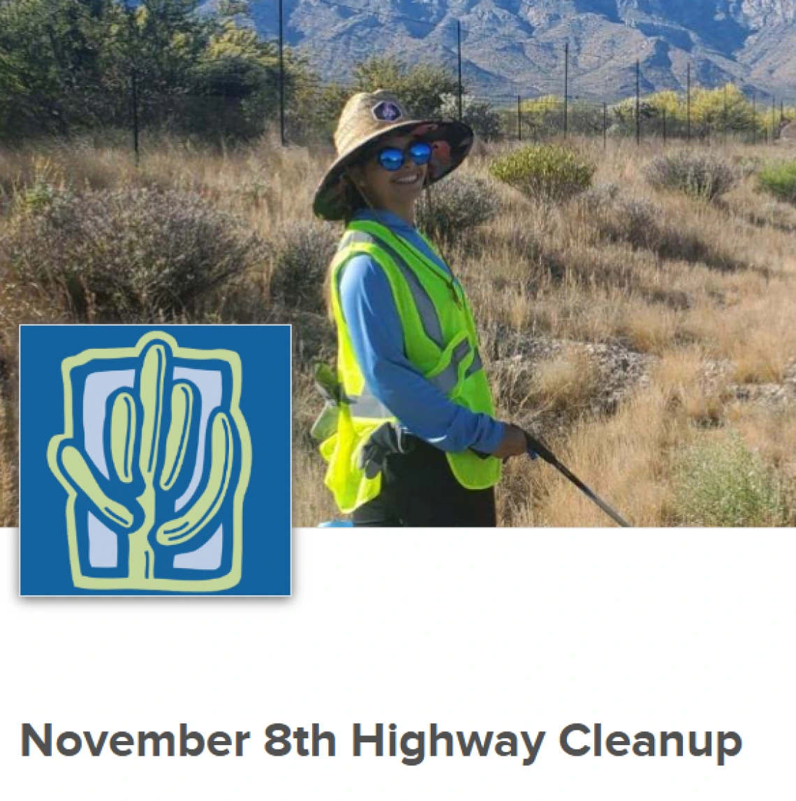 Person in yellow vest picking up trash along a roadway with mountains in the background