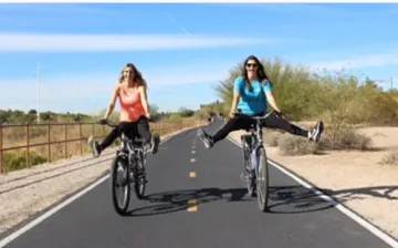 Two people riding bikes along The Loop