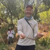 Michael Bogan holding a gopher snake near the Santa Cruz River